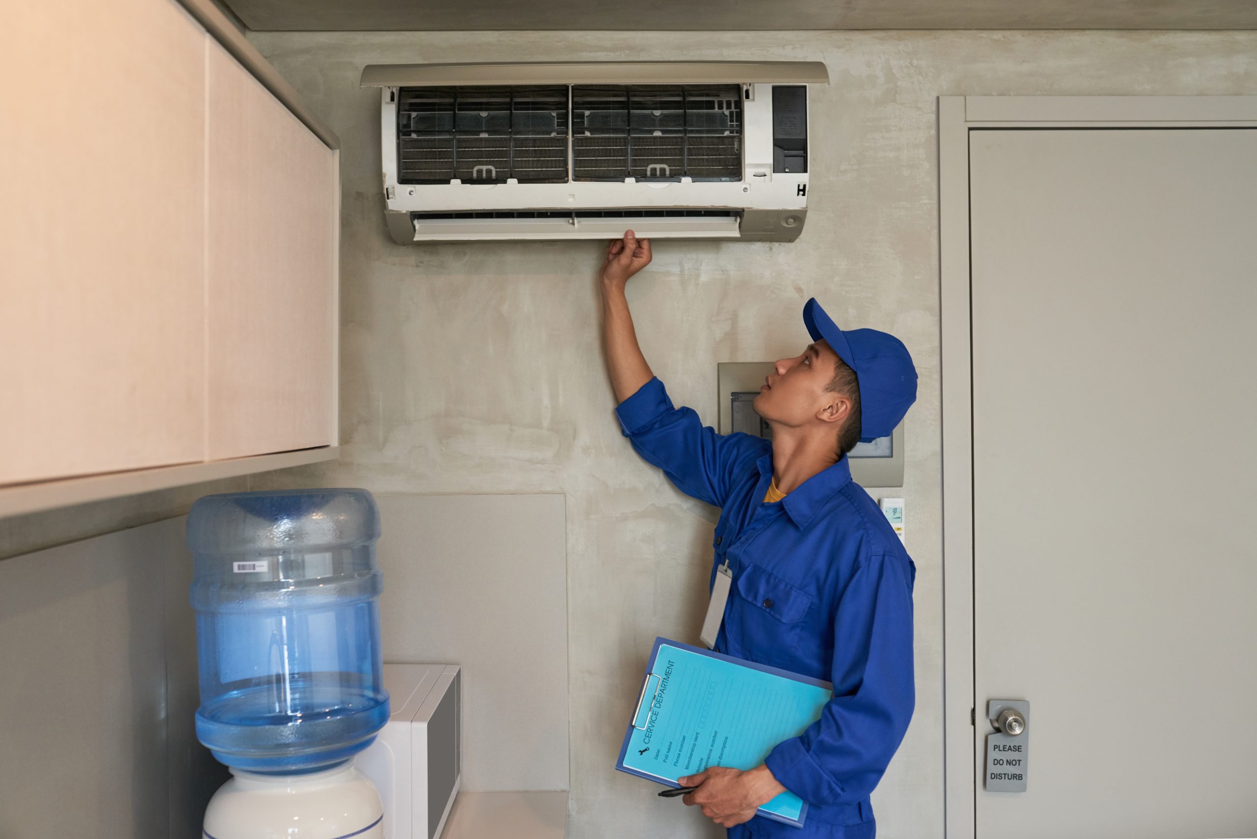 Profissional faz manutenção de  ar condicionado de uma residência